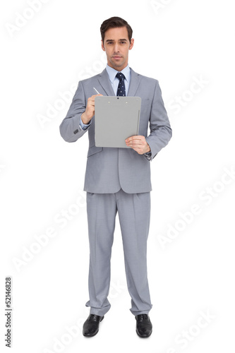 Serious businessman holding a clipboard