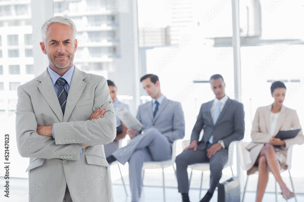 Serious businessman standing in a waiting room Serious businessman standing in a waiting room