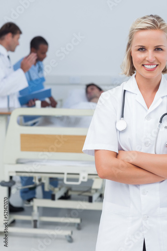 Smiling blonde nurse crossing her arms