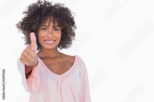 Woman giving thumbs up to camera