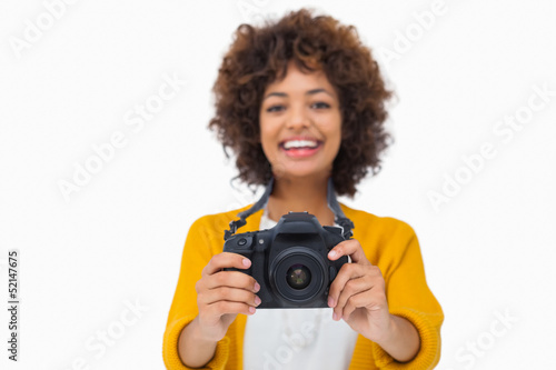 Happy girl holding a camera © WavebreakmediaMicro