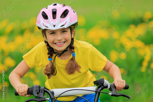 Bike riding - young girl on bike, active child concept