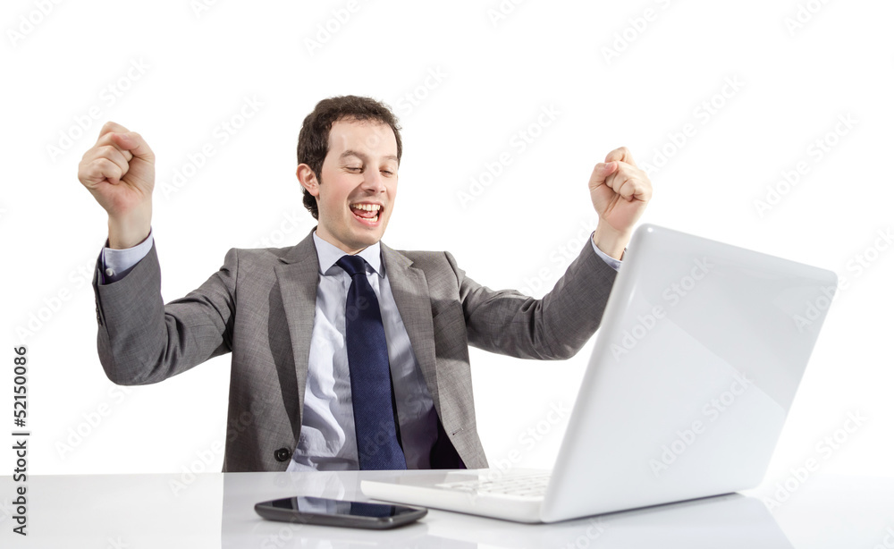 Happy executive man looking a laptop computer with arms raised Happy executive man looking a laptop computer with arms raised