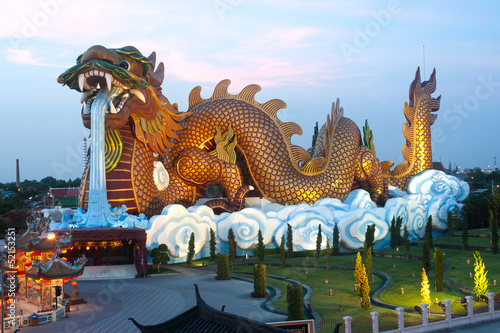 Outdoor night scene of large golden dragon in temple, Thailand. © topten22photo