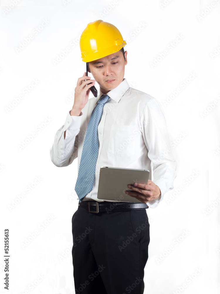 construction supervisor checking on tablet and talking on phone construction supervisor checking on tablet and talking on phone
