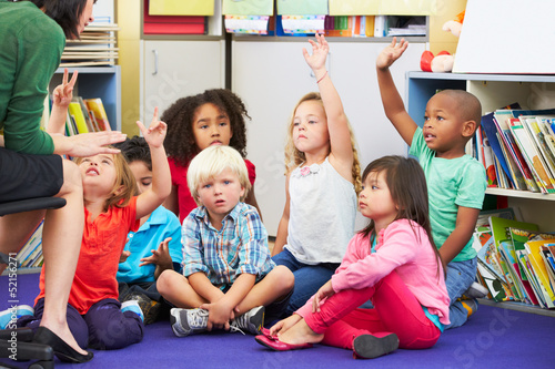 Group of Elementary Pupils In Classroom Answering Question