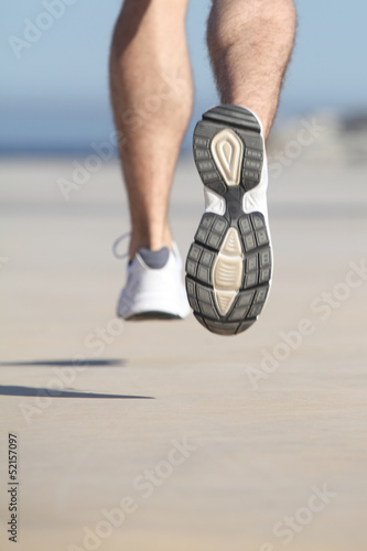 Close up of an unfocused man legs running on the concrete