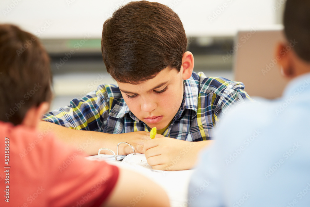 Pupils Studying At Desks In Classroom