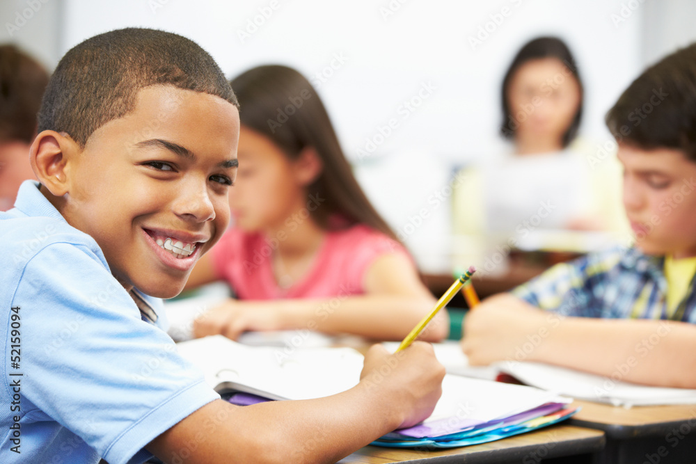 Pupils Studying At Desks In Classroom