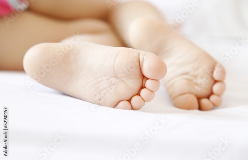 The legs of a young girl sleeping