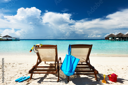 Tropical beach with chaise lounge