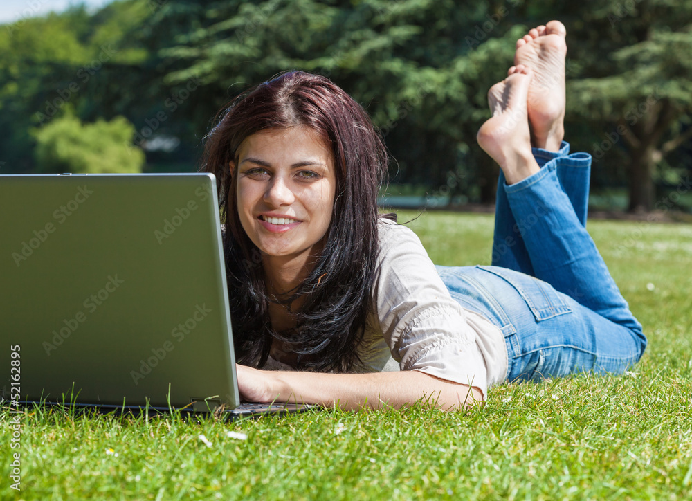 Woman with laptop in summer park Woman with laptop in summer park