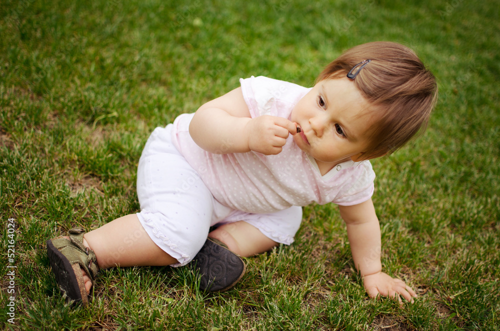 Portrait of beautiful baby girl on the lawn Portrait of beautiful baby girl on the lawn