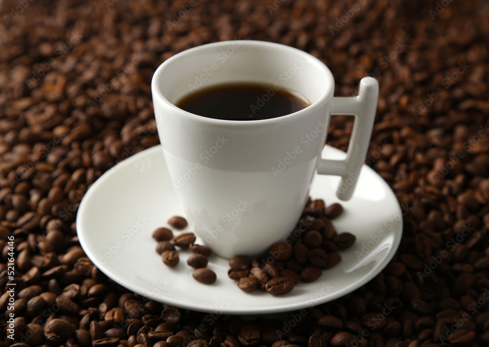 Cup of coffee on coffee beans background Cup of coffee on coffee beans background