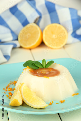 Lemon Panna Cotta with orange zest and caramel sauce,