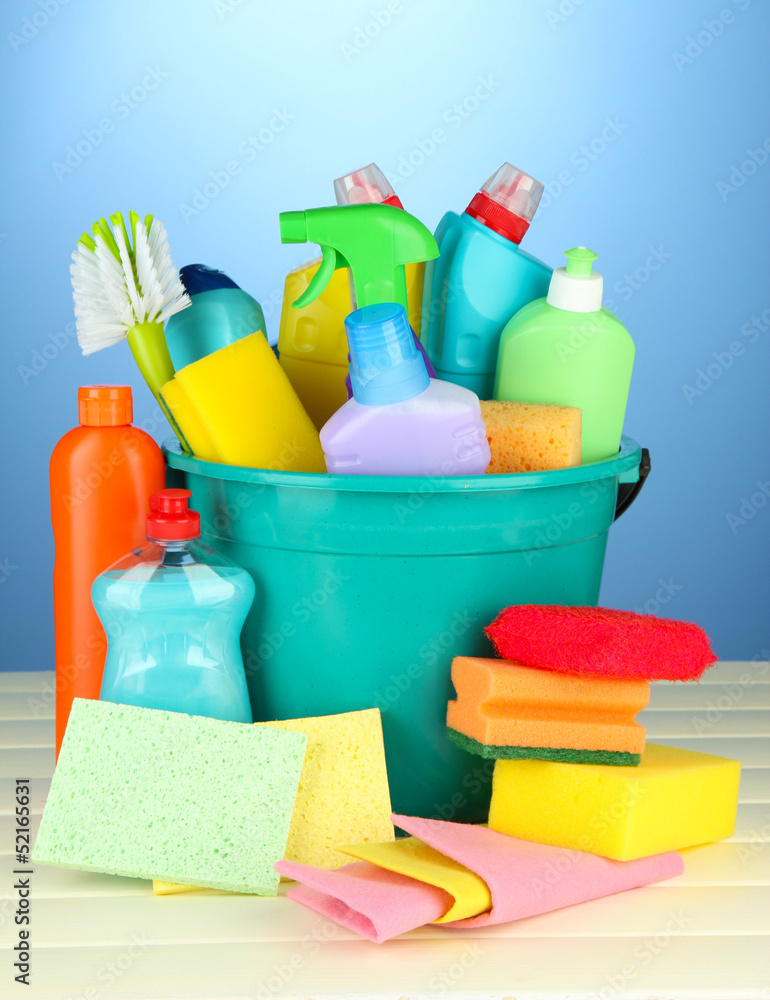 Cleaning items in bucket on color background Cleaning items in bucket on color background