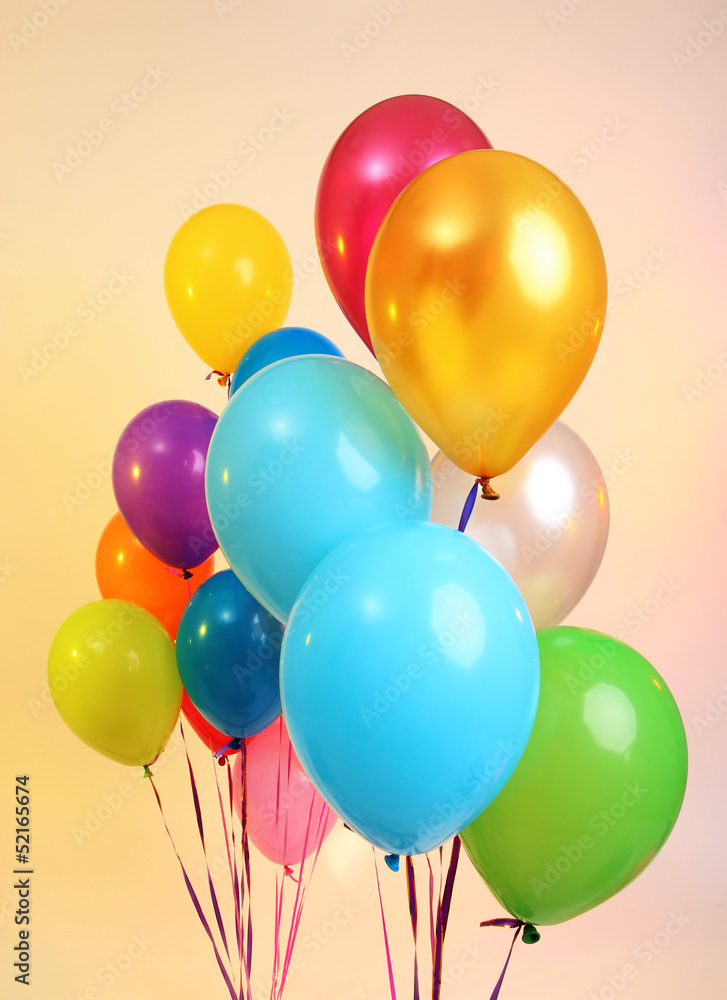 Many bright balloons on orange background