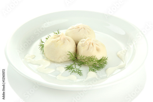 Tasty khinkali on plate, isolated on white