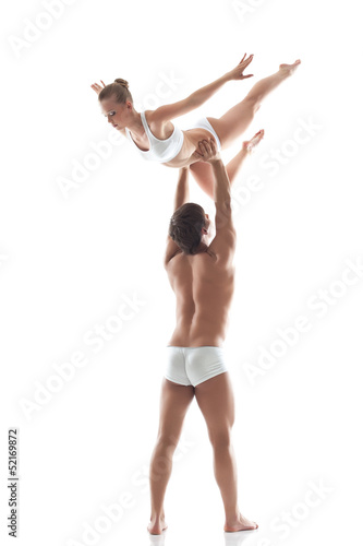Muscular man holds young slim woman