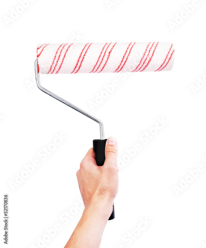 Hand holding roller brush isolated on white photo