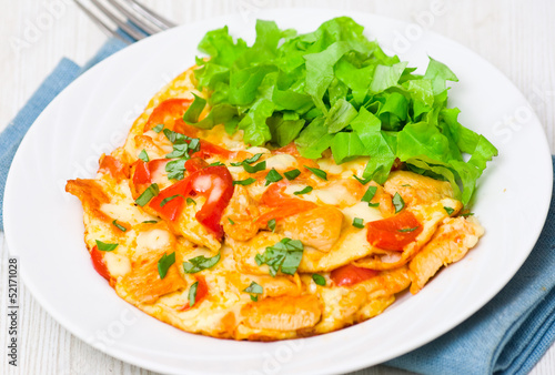 omelette with slices of chicken breast and vegetables