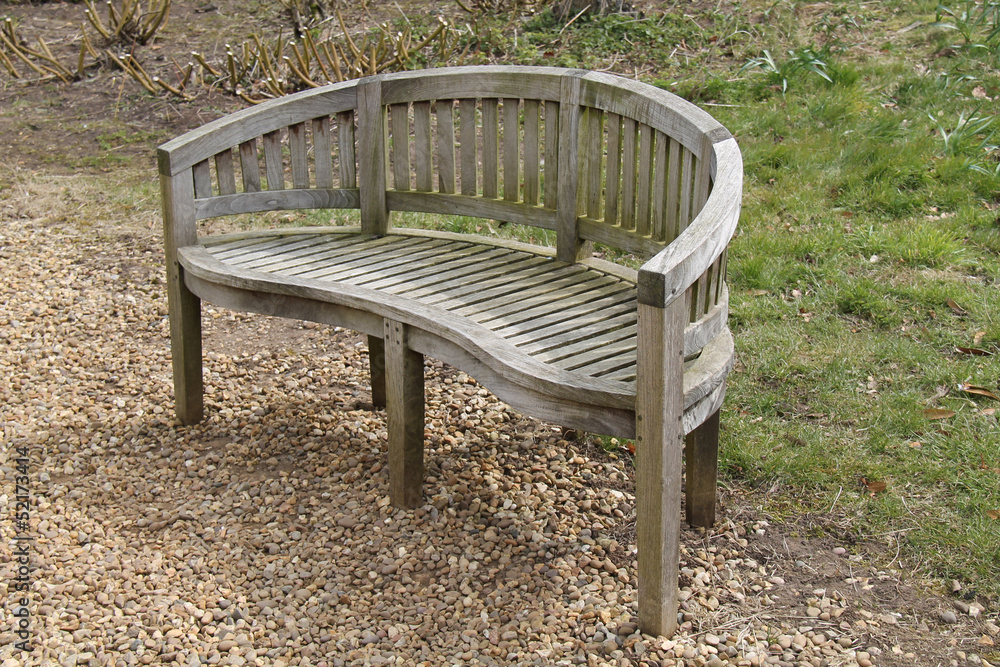 A Wooden Garden Bench with a Round Back.