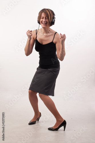 Funny photo of young casual business woman listening to music on