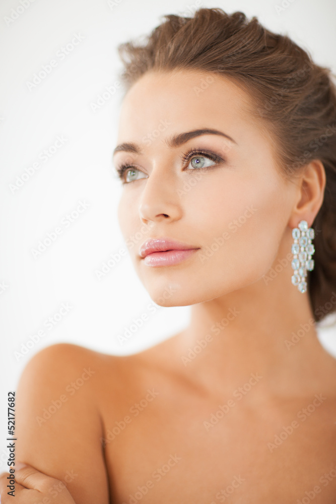 woman wearing shiny diamond earrings