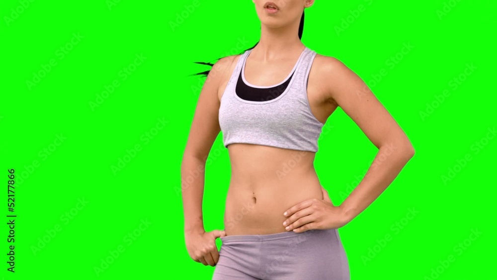 Athletic woman tossing hair on green screen Athletic woman tossing hair on green screen