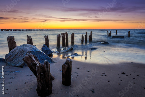 Stones and breakwater at sunset