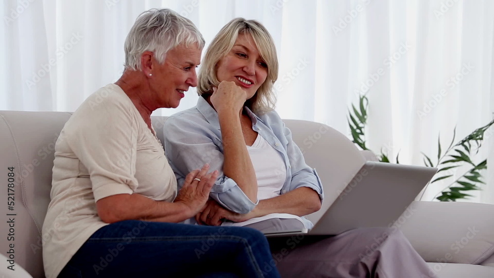 Two friends using a laptop Two friends using a laptop