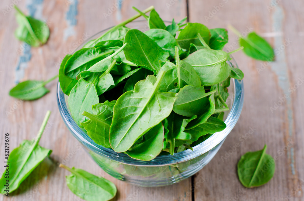 Spinach in a glass bowl on the table Spinach in a glass bowl on the table