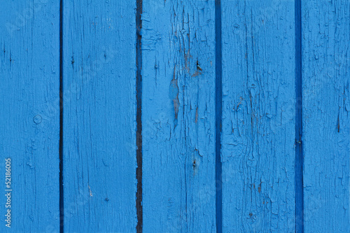 Old fence painted in blue colour - background