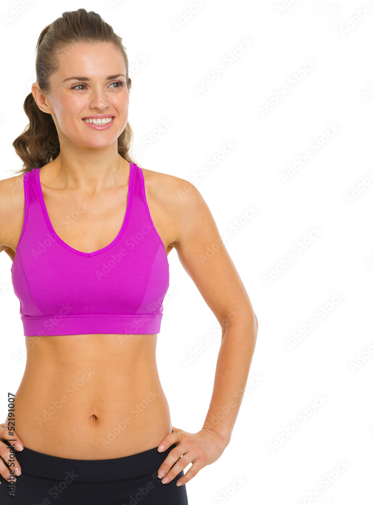 Smiling fitness young woman looking on copy space