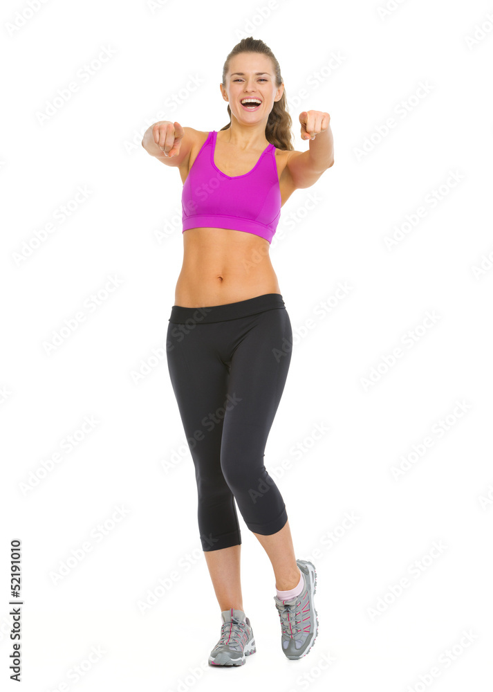 Happy fitness young woman pointing in camera Happy fitness young woman pointing in camera