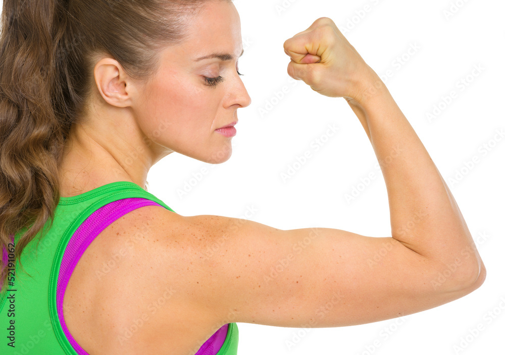 Fitness young woman showing biceps Fitness young woman showing biceps