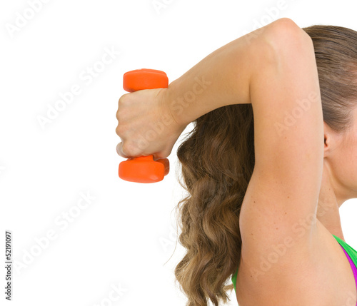 Closeup on woman athlete making exercise with dumbbells