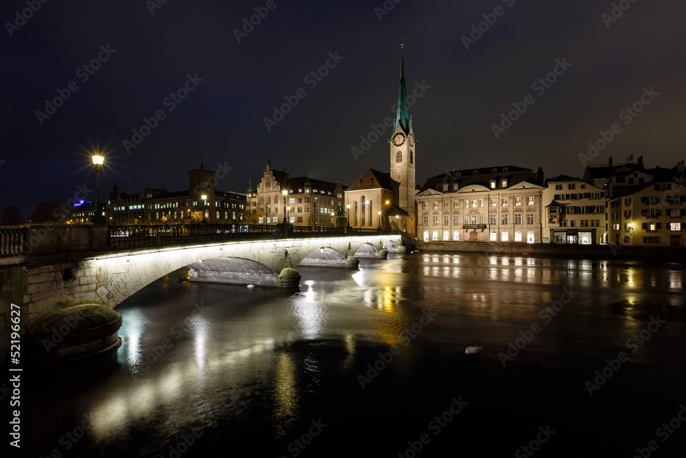 Illuminated Fraumunster Church and River Limmat in Zurich, Switz