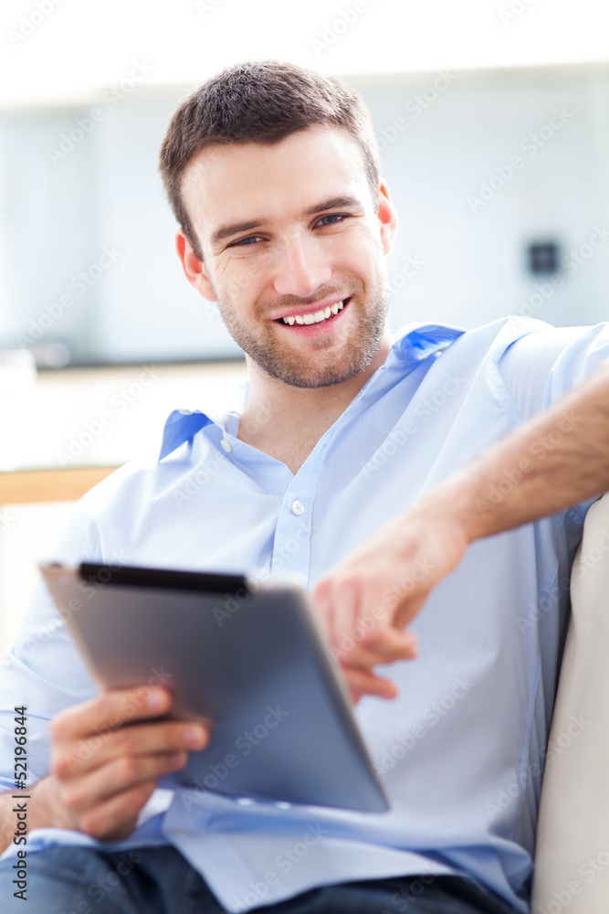 Man relaxing with digital tablet Man relaxing with digital tablet