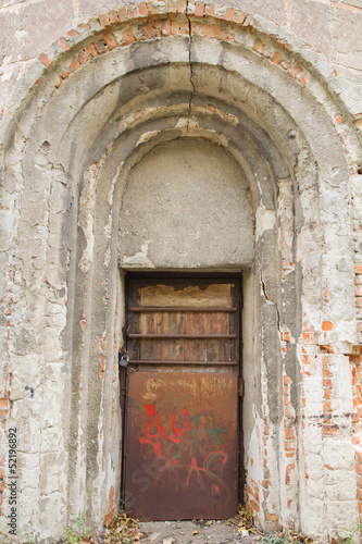 Old arched abandoned door