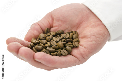 Male hand holding coffee beans