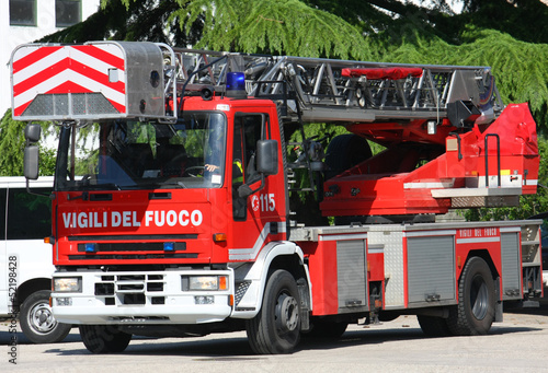 truck with ladder of the fire brigade arrives in speed at the pl