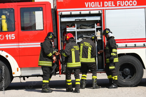 Firefighters prepare for the tools from the truck during a serio