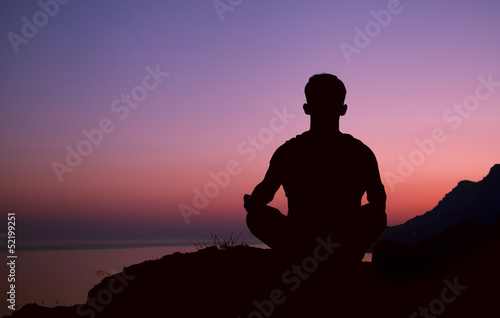 Sitting man silhouette in meditation pose