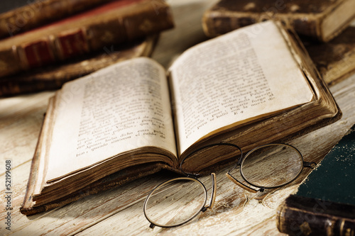 antique book with old spectacles photo