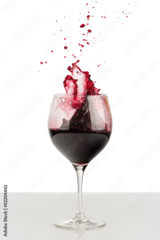 Splash of red wine in a wineglass. Splash of red wine in a wineglass.