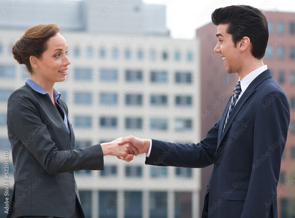 Businessman and business woman handshake outdoors Businessman and business woman handshake outdoors