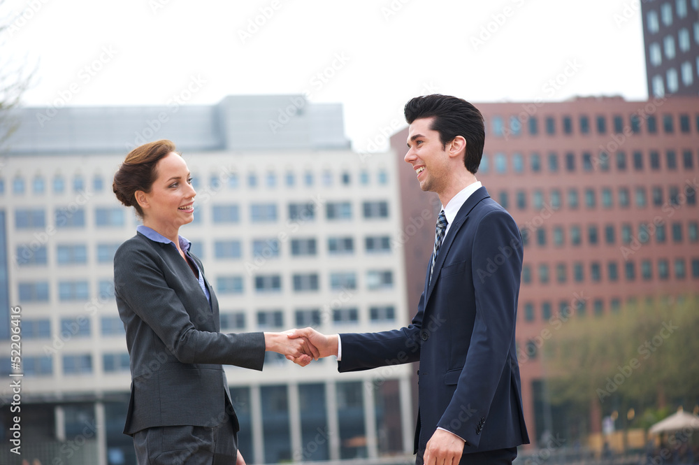 Businessman and business woman greeting with a handshake Businessman and business woman greeting with a handshake