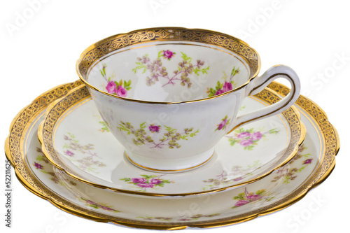 Canvas Print Antique tea cup, saucer and small plate.