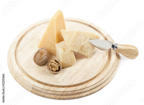 Nuts and cheese on wooden board. On white background.